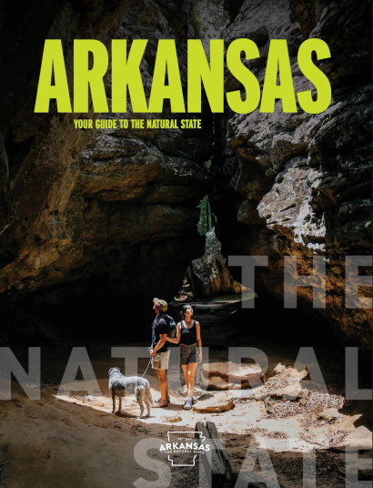 Arkansas Travel Guide: A scenic view of the Buffalo National River with towering limestone bluffs and clear water.